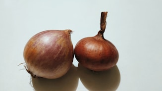 two onions sitting next to each other on a table