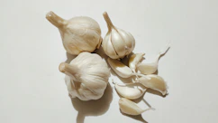a couple of garlic bulbs sitting on top of a table