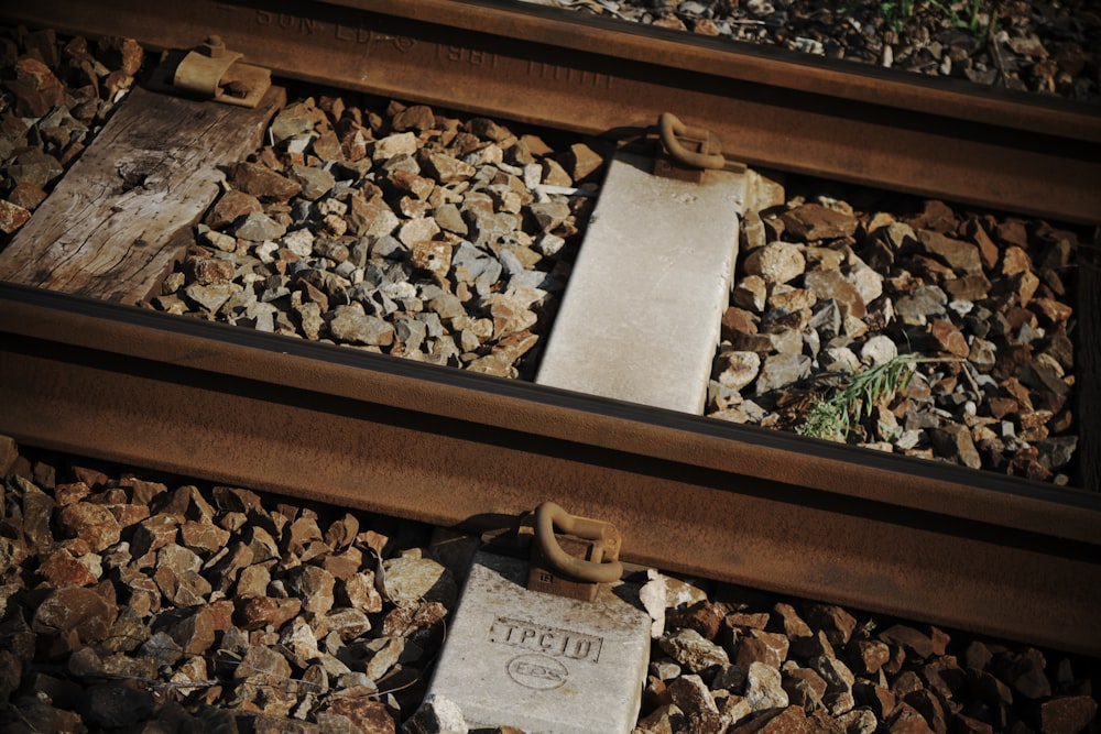 a close up of a train track with rocks