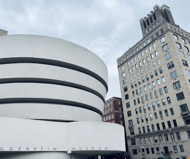 a large building with a white circular structure in front of it