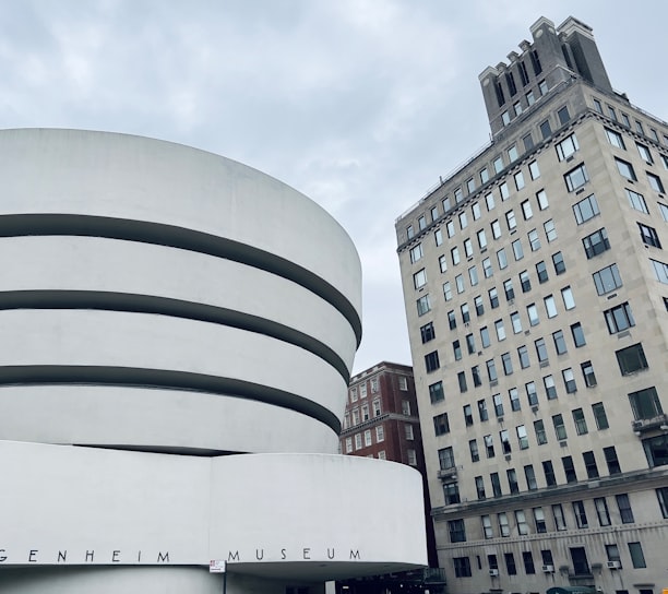 a large building with a white circular structure in front of it