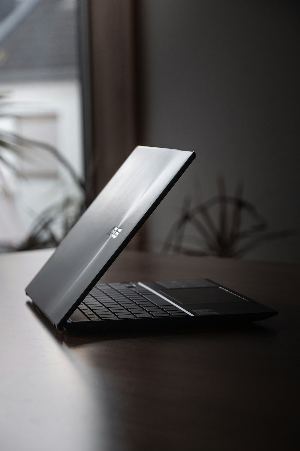 a laptop computer sitting on top of a wooden desk