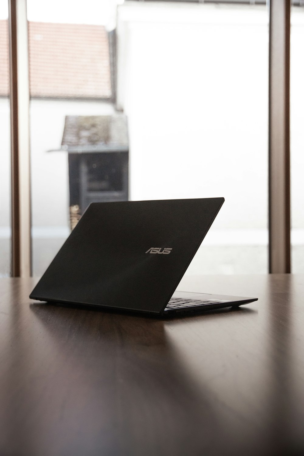 a laptop computer sitting on top of a wooden table