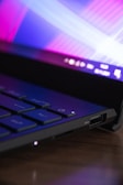 a laptop computer sitting on top of a wooden table