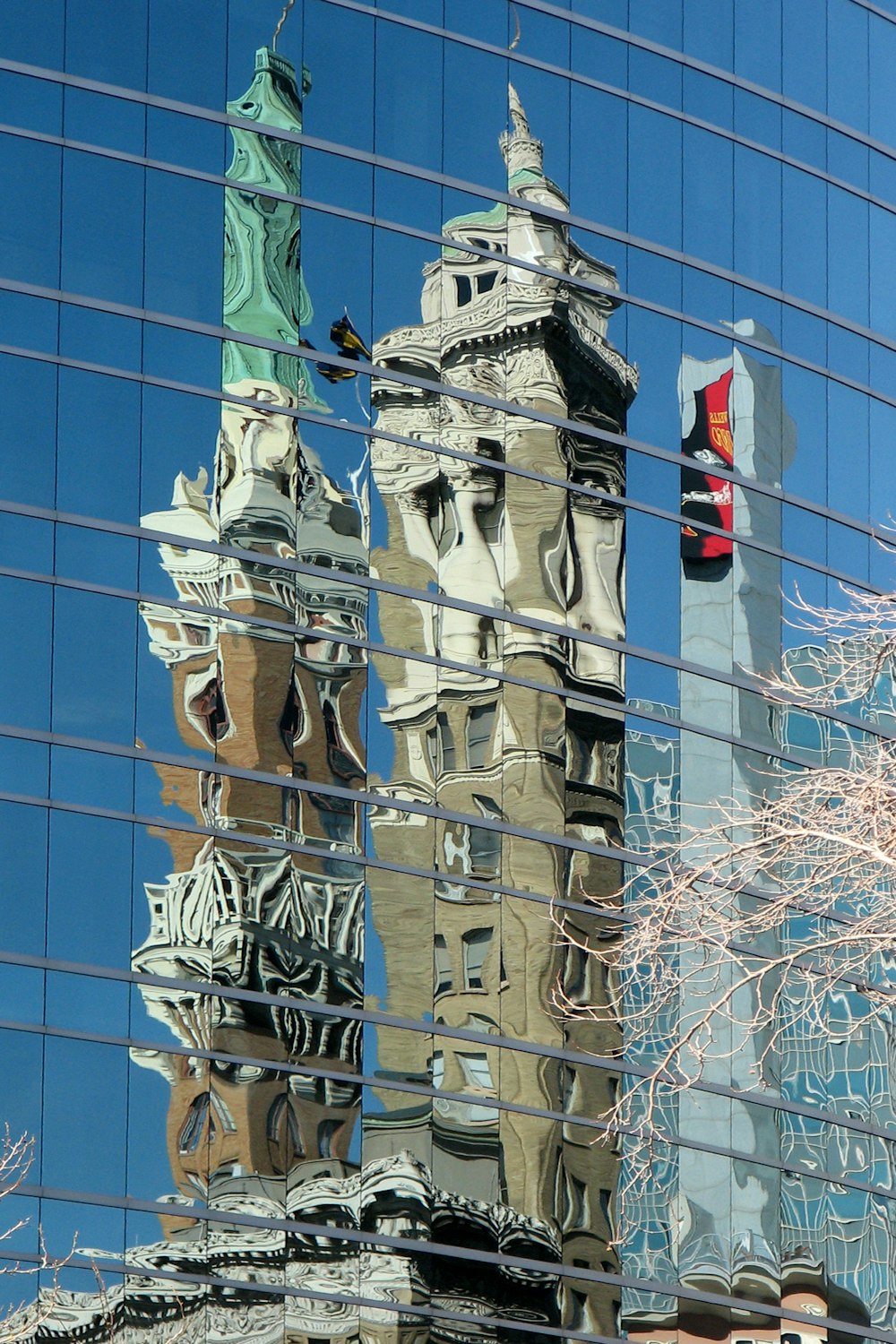 a reflection of a building in the glass of another building