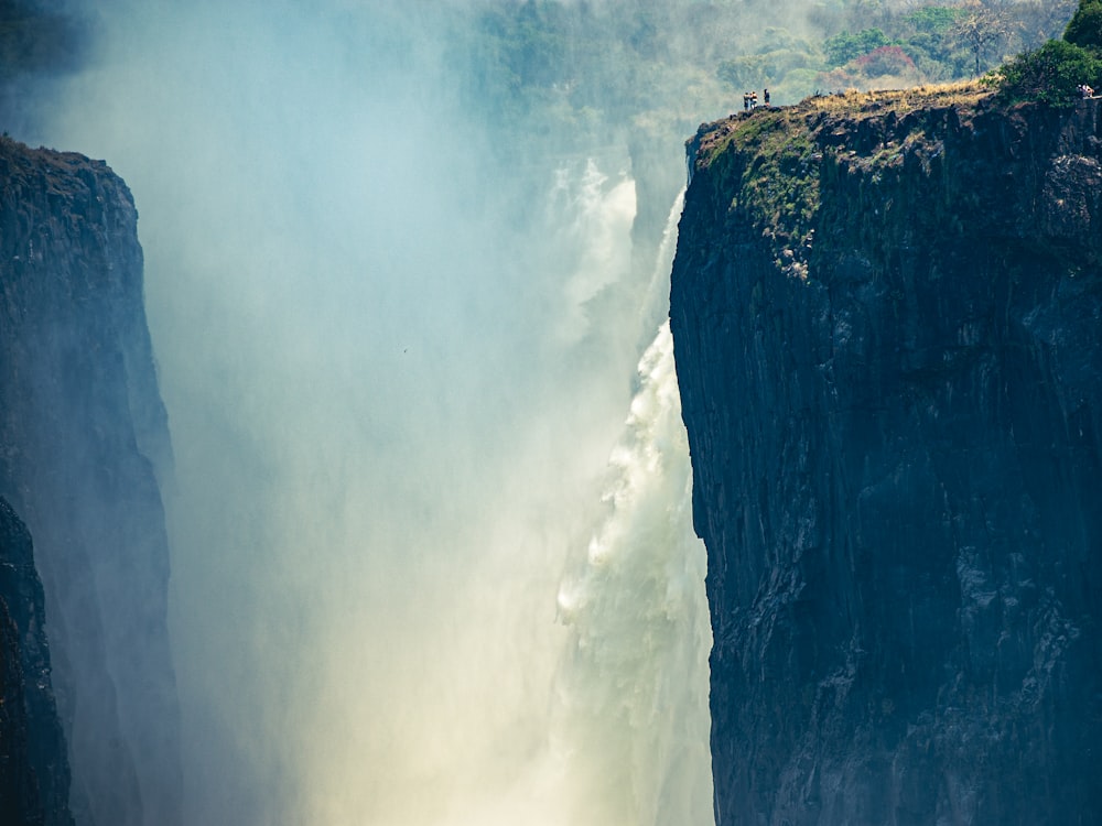 a man standing on the edge of a waterfall