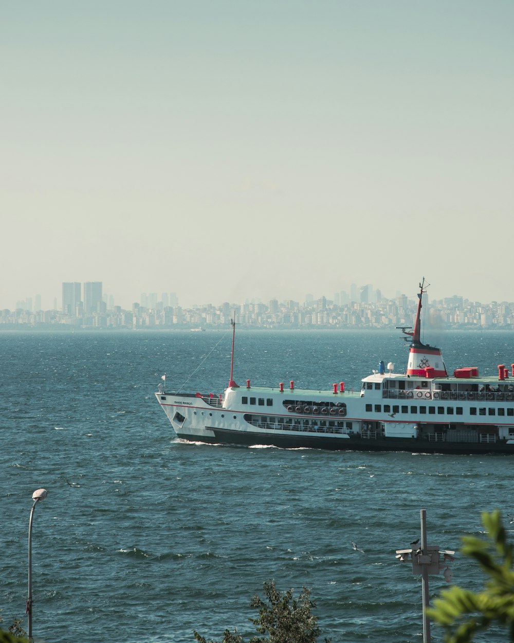 a large white boat in the middle of a body of water