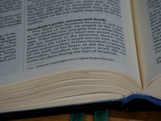An open book displaying a page with text discussing Hezekiah's pride, success, and death. The page appears to be from a religious or historical text, with a focus on a narrative involving prayer and repentance.
