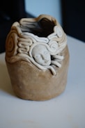 a ceramic sculpture of a head on a table