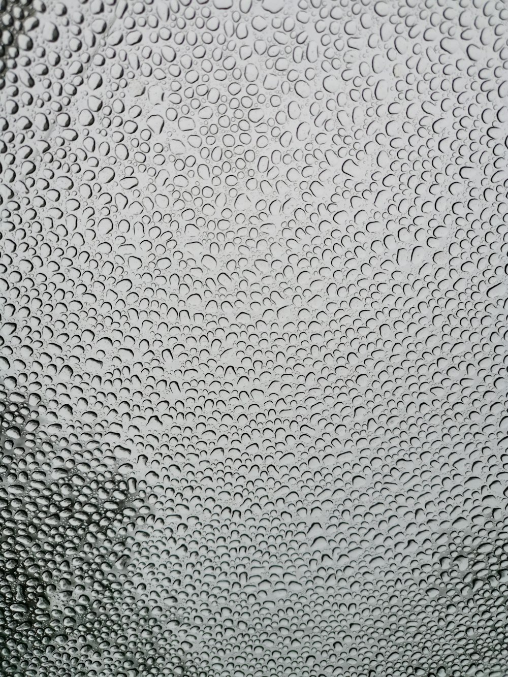 a close up of a glass window with drops of water