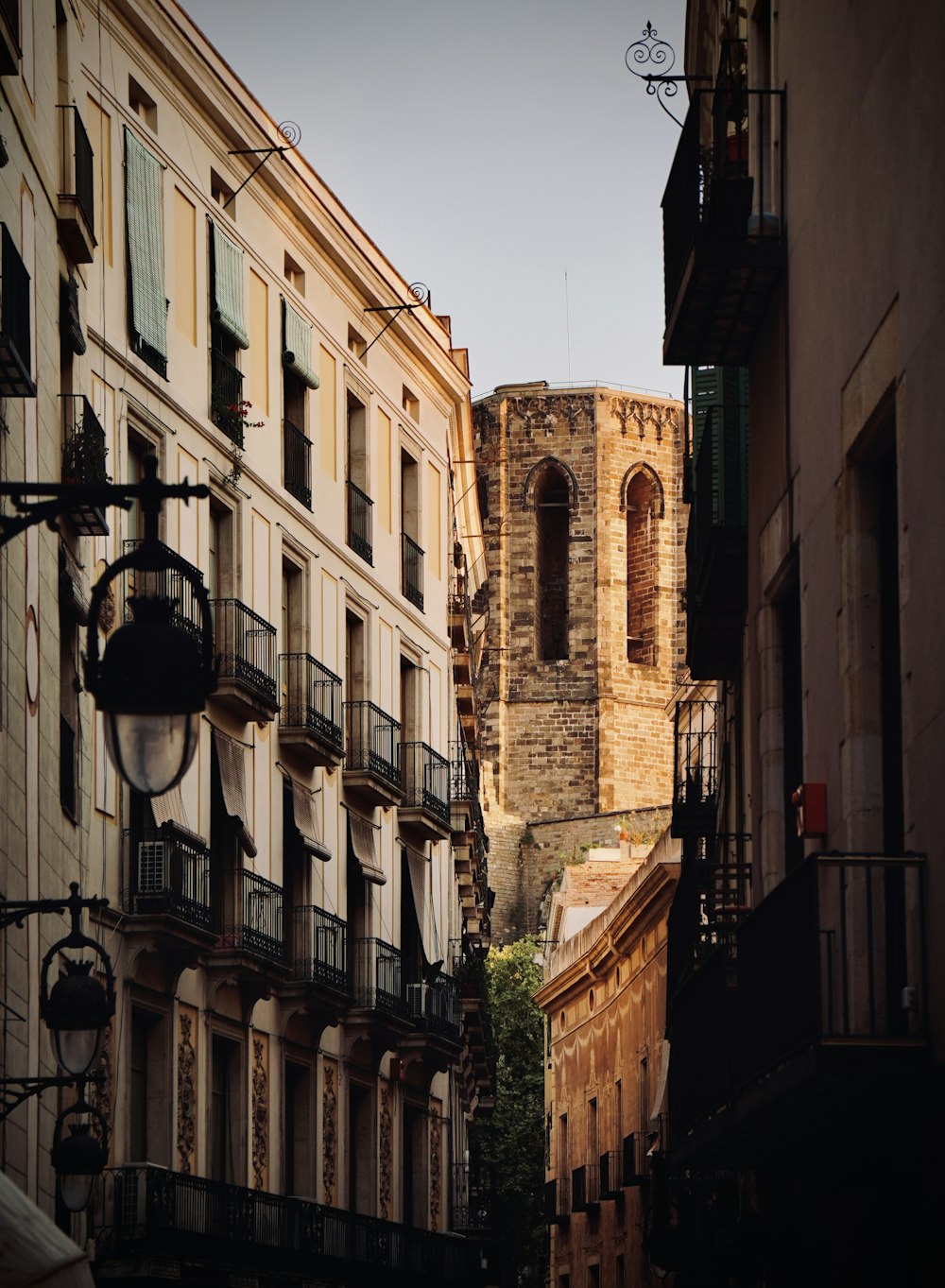 a city street with buildings and a clock tower in the background