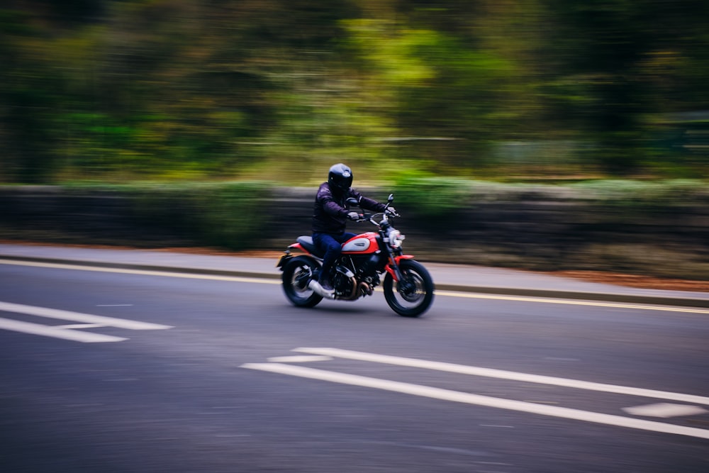 a person riding a motorcycle down a street