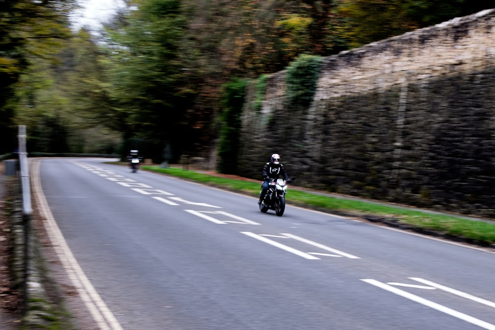 a man riding a motorcycle down a curvy road