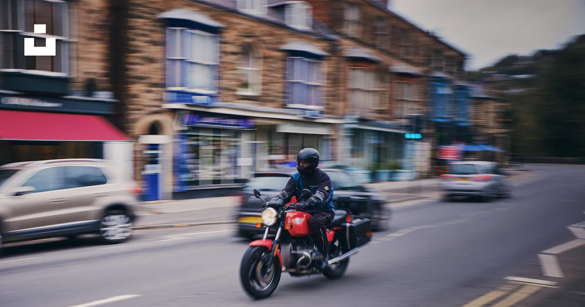 Street Riding Motorcycle A person riding a motorcycle on a city street photo – Free Motorcycle ...