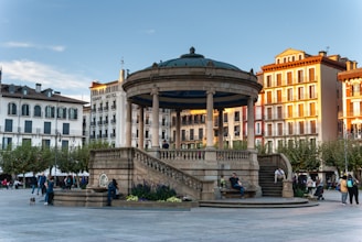 a group of people standing around a fountain