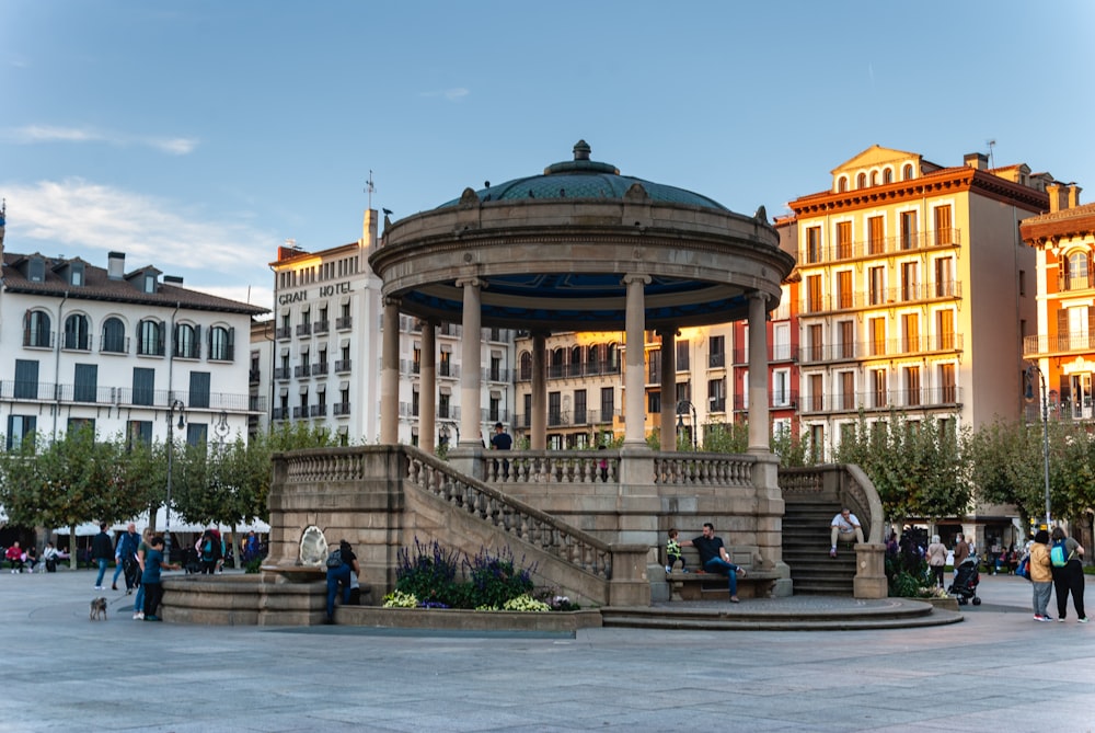 a group of people standing around a fountain