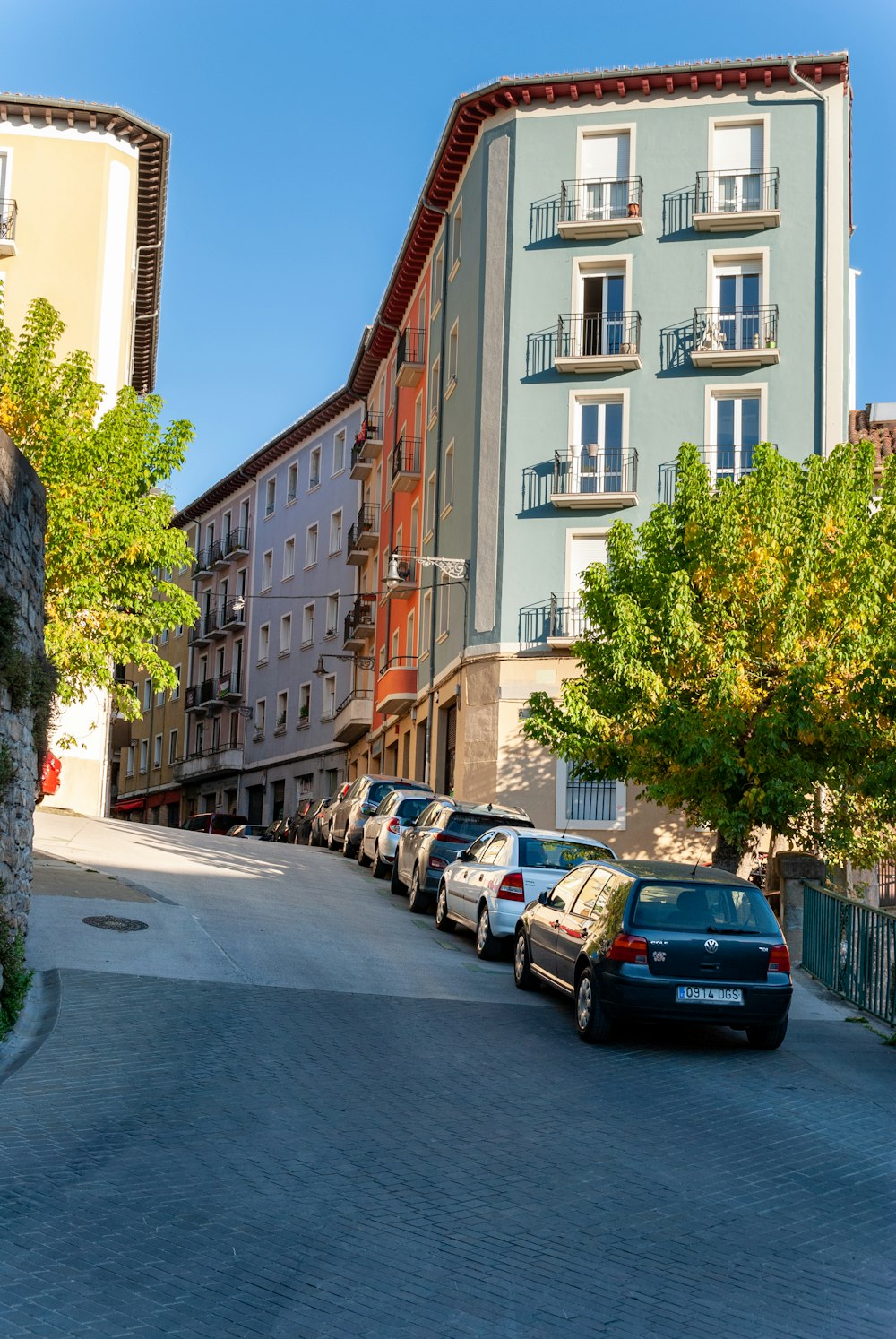 a row of parked cars on a city street