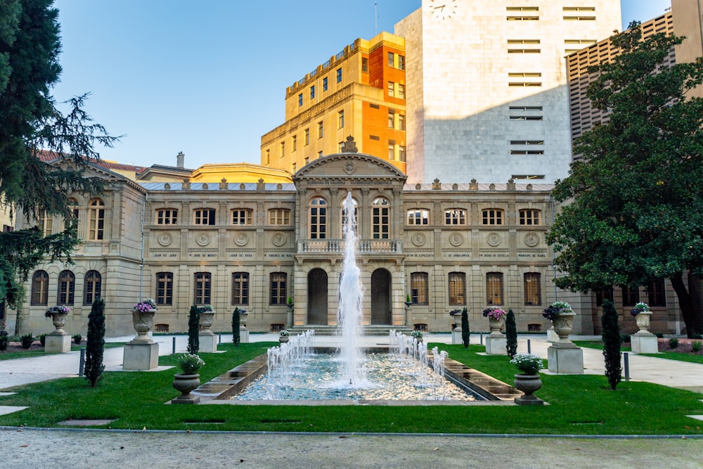 a large building with a fountain in front of it