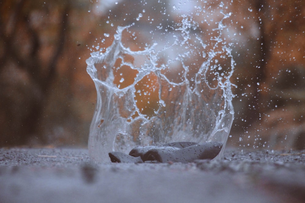 a glass with water splashing out of it