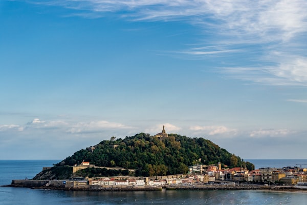 A small green island in the middle of the bay off San Sebastian