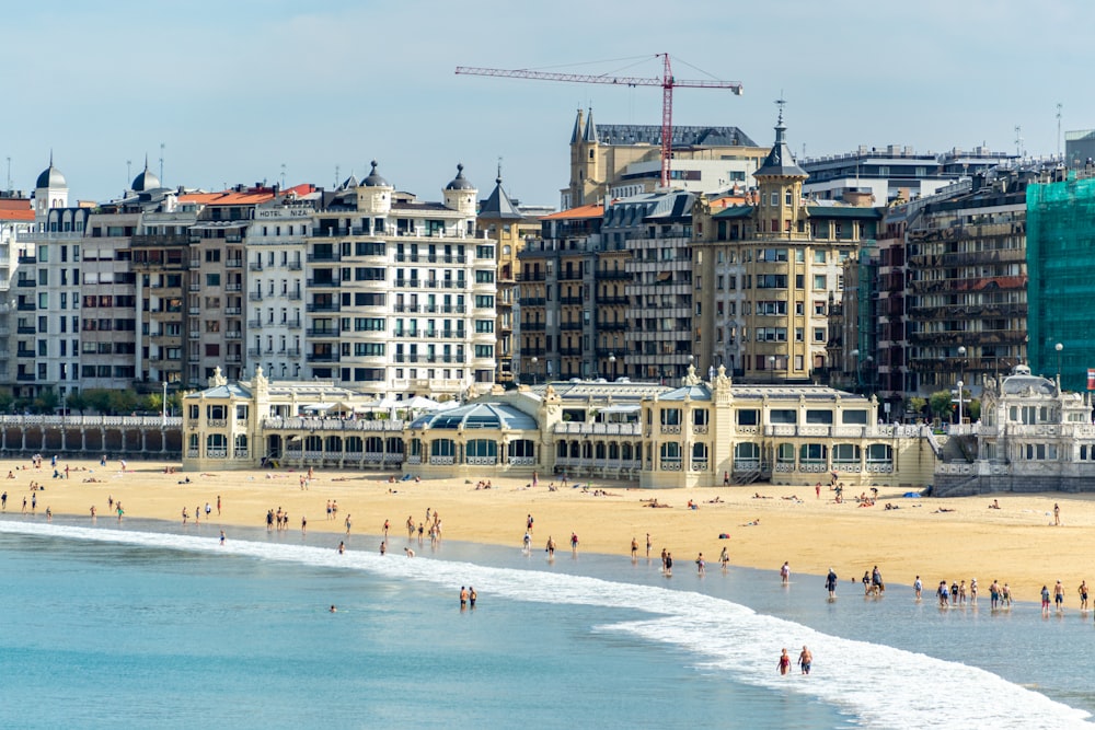 a group of people standing on top of a sandy beach