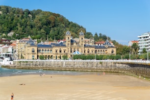 a beach with a large building in the background