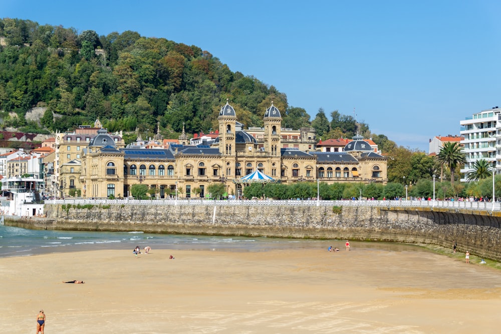 a beach with a large building in the background