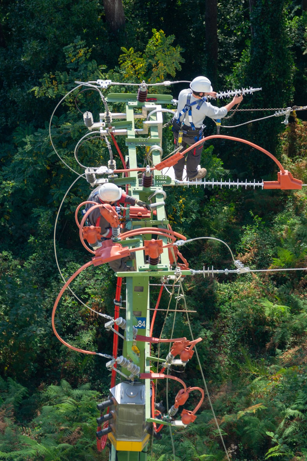 a man in a white shirt is on a high wire