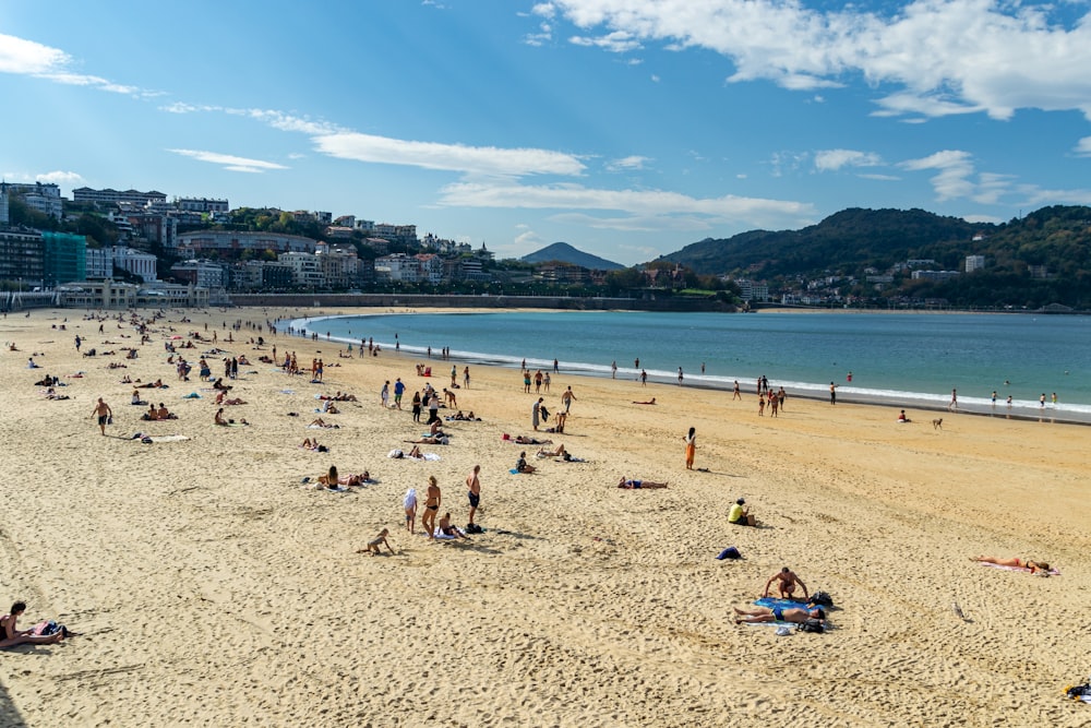 a crowded beach with many people on it