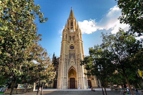 Ornate cathedral facade with a clock in San Sebastian