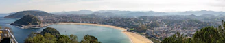 A panoramic view of the stunning bay and beach of São Martinho do Porto, with clear blue waters and golden sand.
