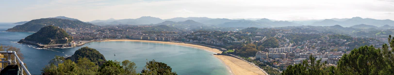 A panoramic view of the stunning bay and beach of São Martinho do Porto, with clear blue waters and golden sand.