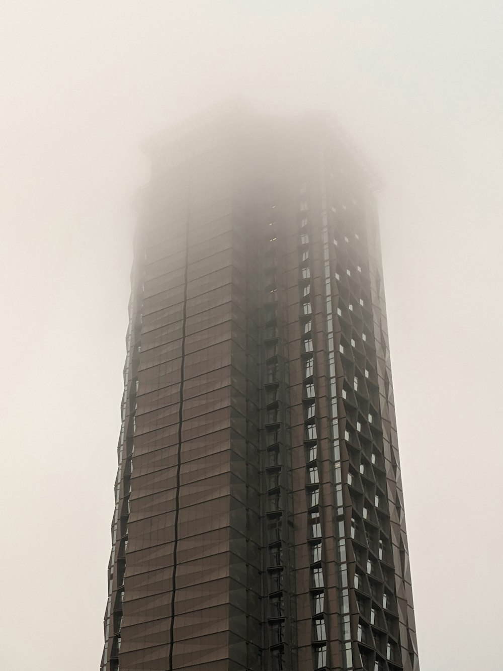 a very tall building with a very tall clock on it's side