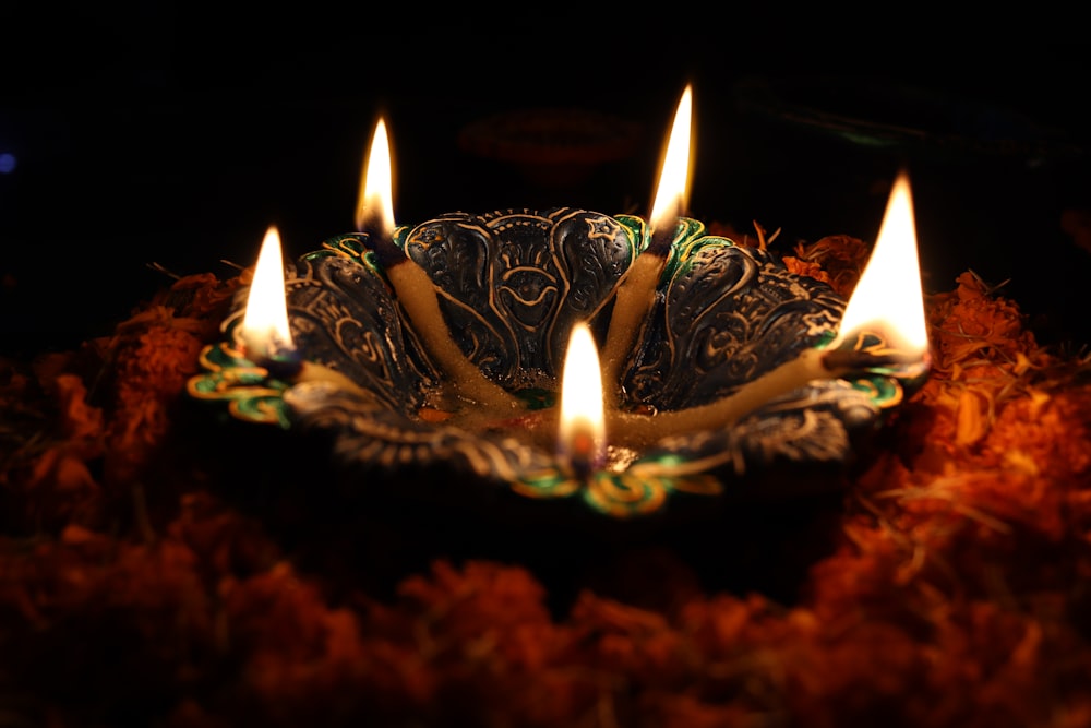 a group of lit candles sitting on top of a plate