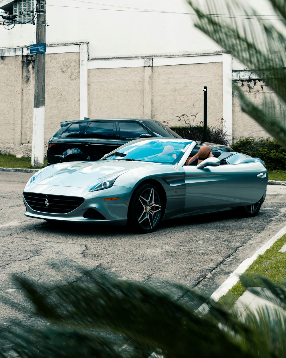 a blue sports car parked in a parking lot