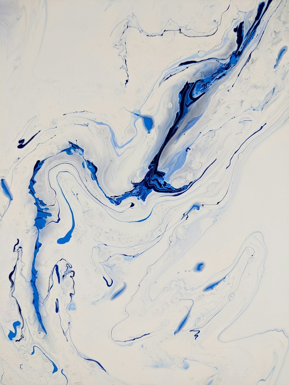 a painting of blue and white swirls on a white background