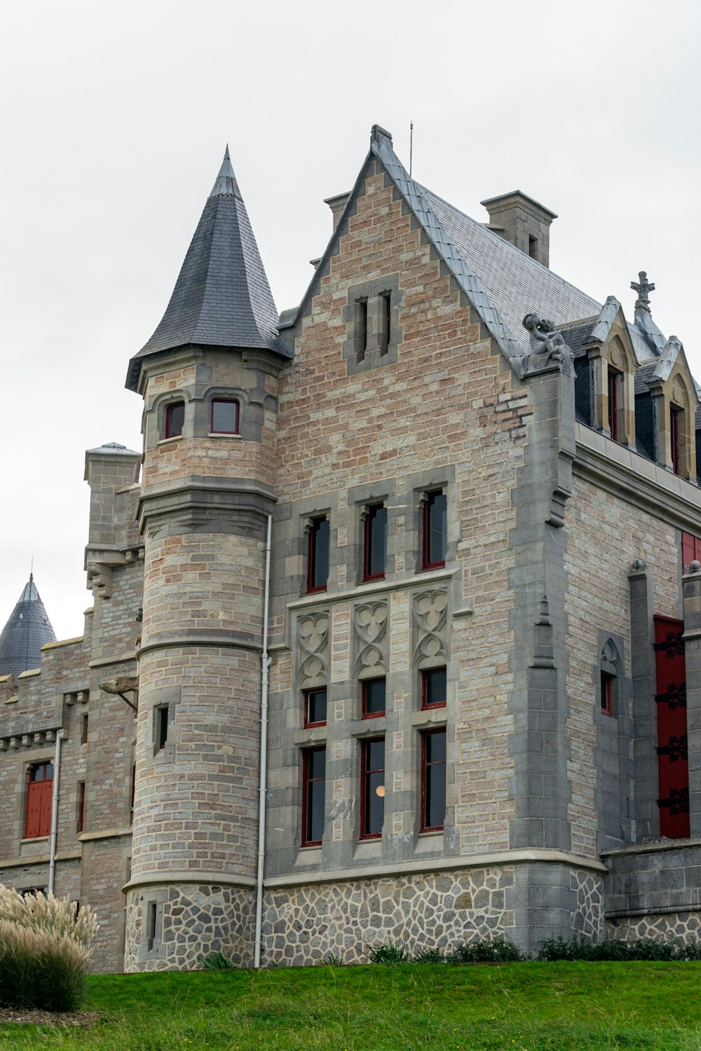 a castle like building with a clock on the front of it