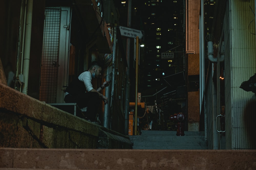 a man walking down a flight of stairs at night