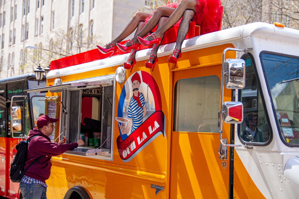 a woman standing in front of a food truck