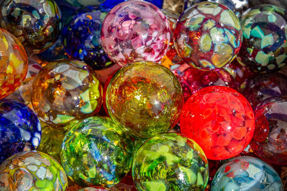 a pile of colorful glass balls sitting on top of each other