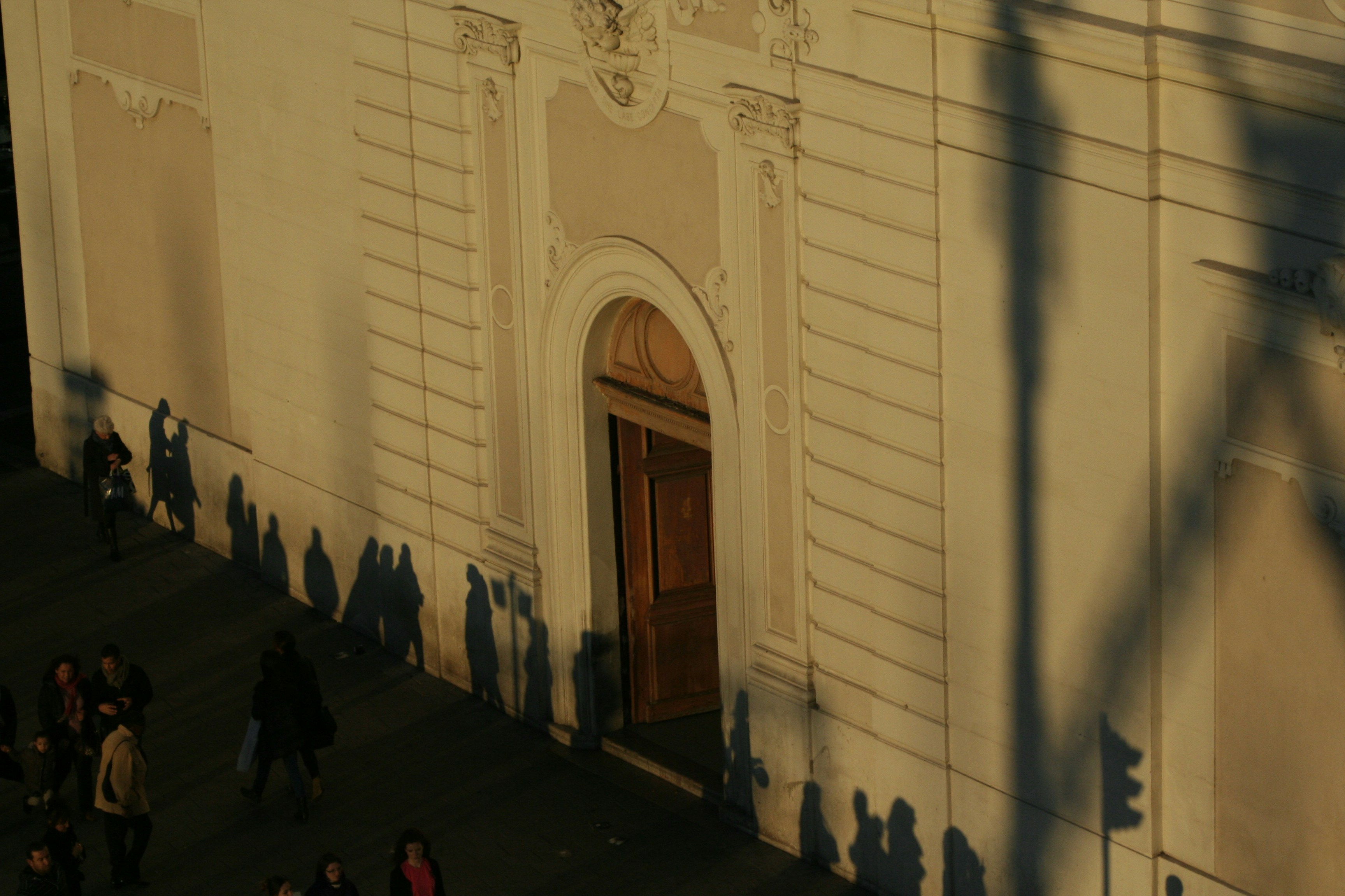 a group of people walking down a street next to a building