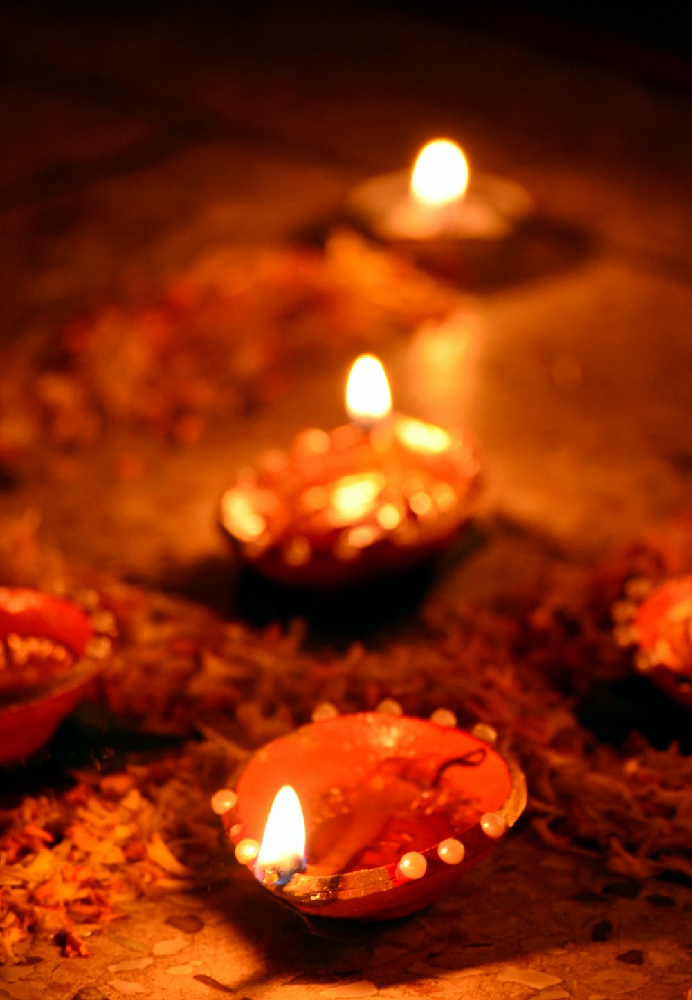 a group of lit candles sitting on top of a floor