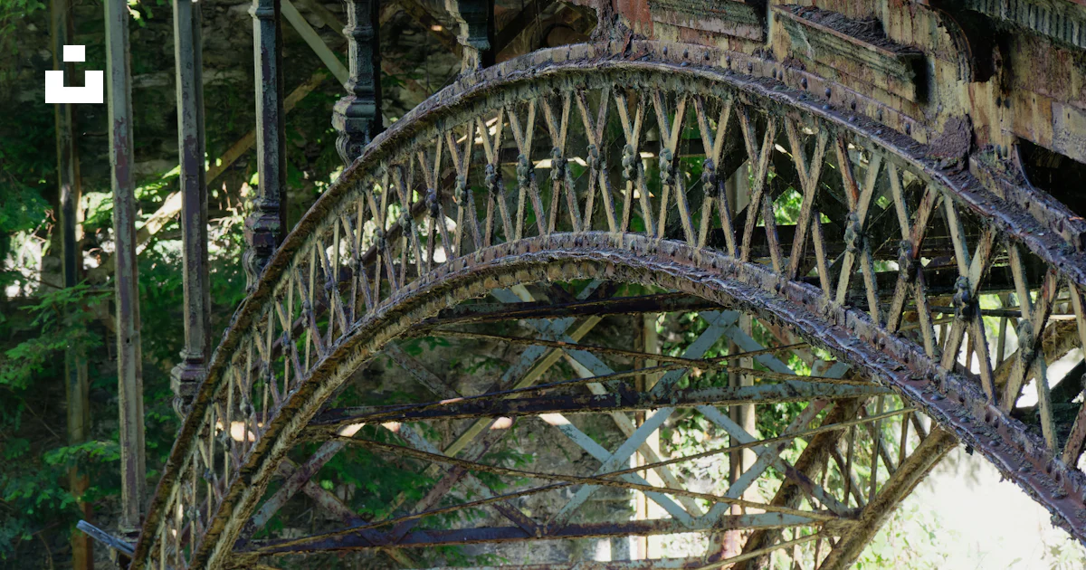 A very old bridge that has a bunch of rust on it photo – Free Bridge ...