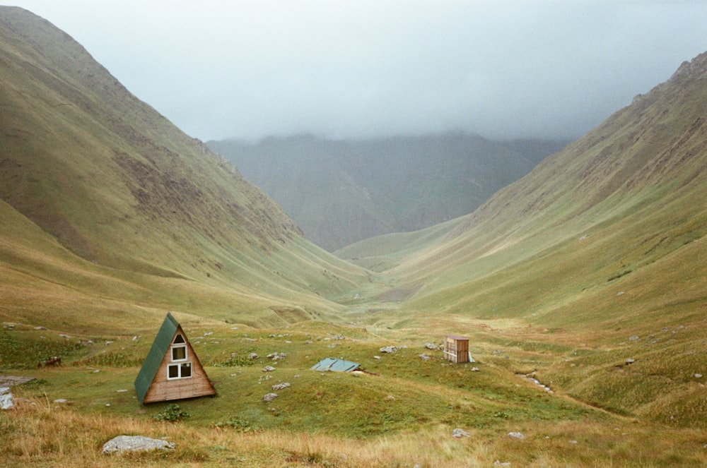 a small house in the middle of a valley