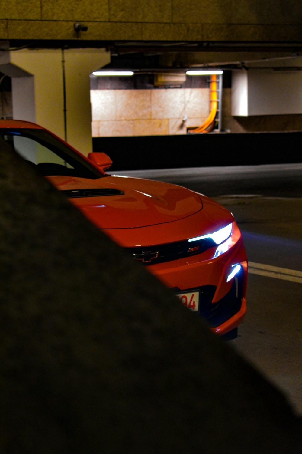 a red sports car parked in a parking garage