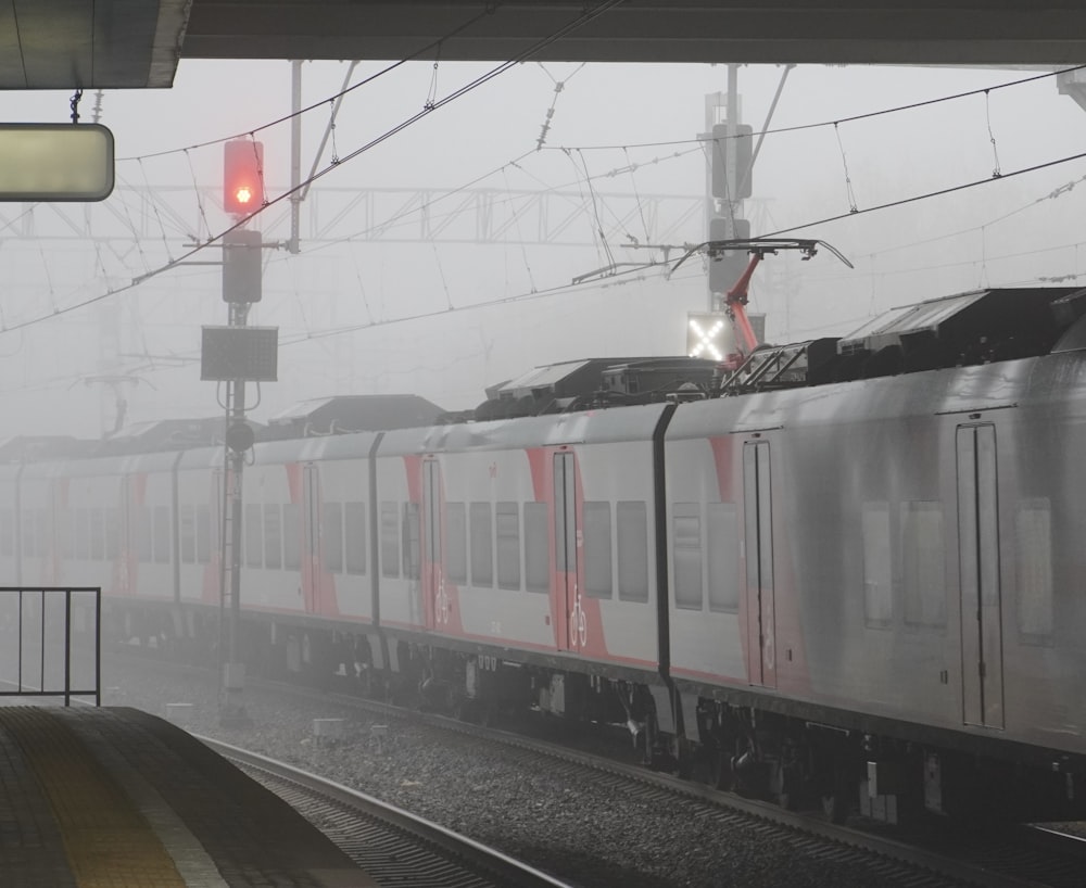 a train traveling through a foggy train station