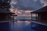 Sunset view over a private infinity pool at Cherai beach resort.