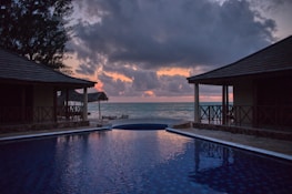 A serene beach villa with sunset views, inviting travelers to book their stay.
