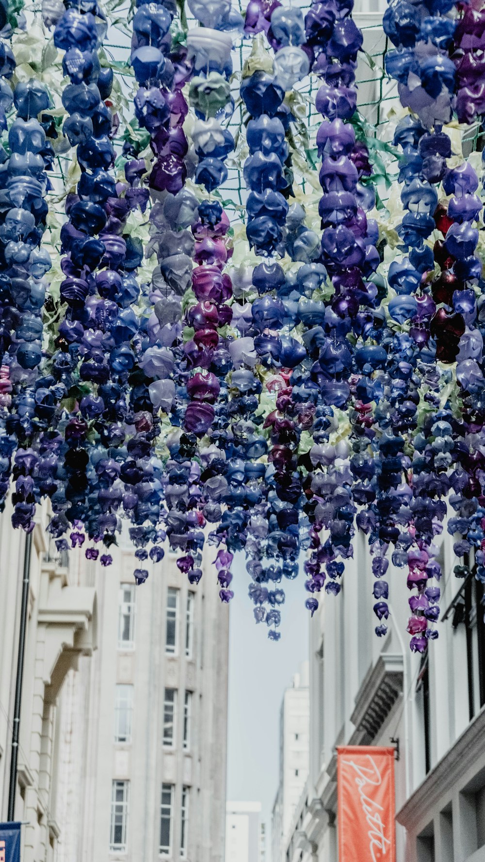 a bunch of glass beads hanging from a ceiling