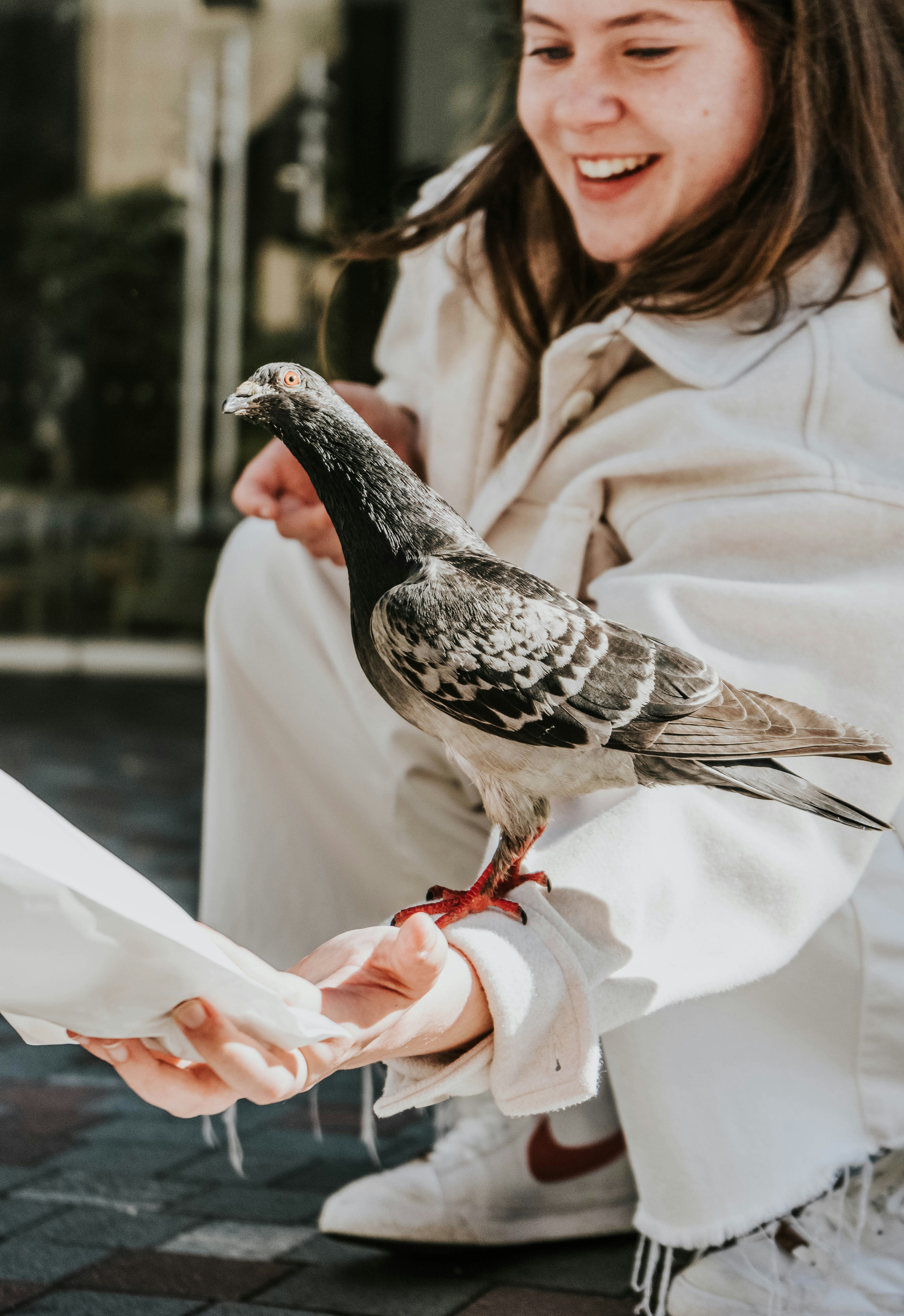 a woman holding a bird on her hand